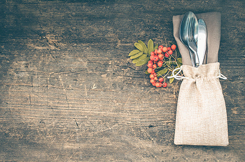 Thanksgiving autumn place setting with cutlery on wooden background. Thanksgiving table setting cutlery on the autumn background. Thanksgiving holidays background concept. Copy space. Top view.