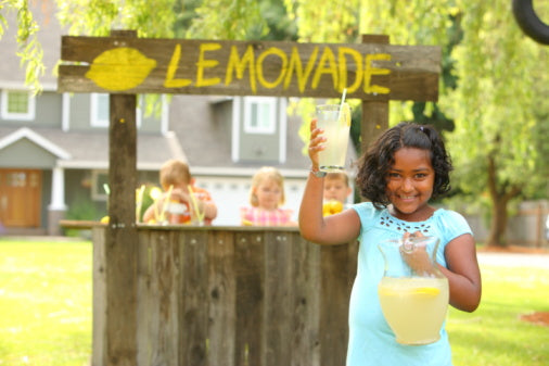 Young girl in front of lemonade stand,The Blessings Jar book for kids
