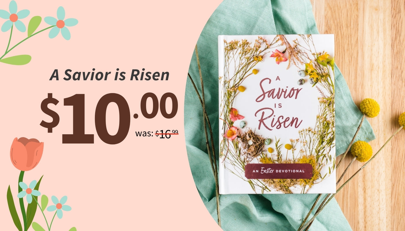 Book titled 'A Savior is Risen' with floral design on a pink background