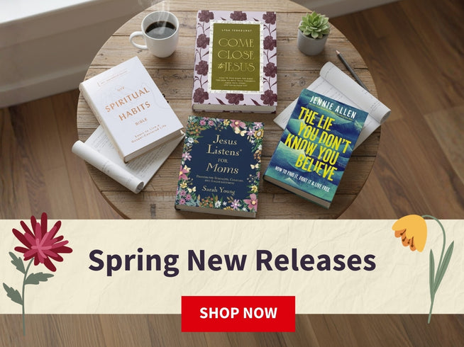 Table with books and a cup of coffee, featuring spring new releases on a wooden floor.