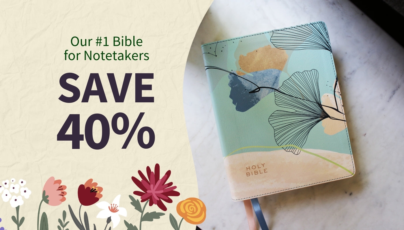 Floral notebook with promotional text for a Bible sale on a marble surface