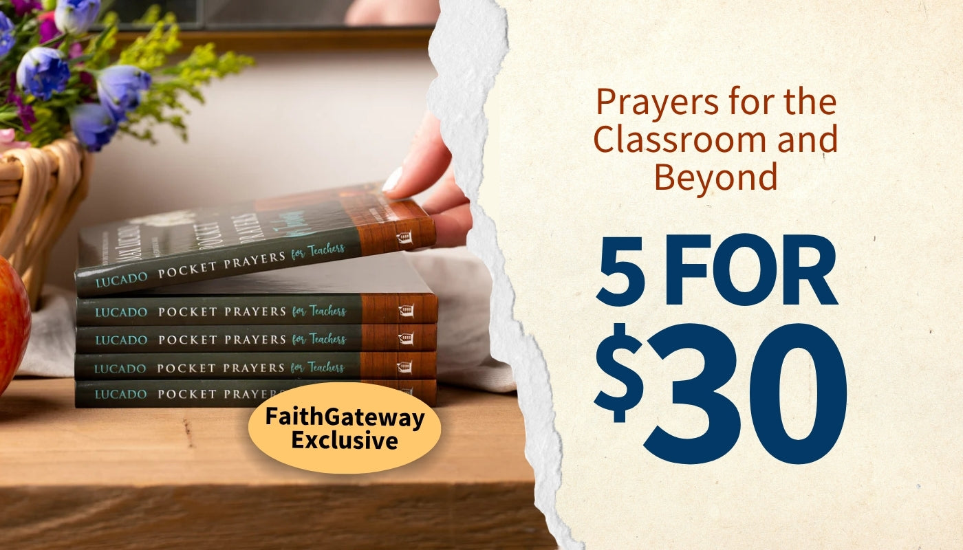 A promotional graphic showing a hand holding a stack of 'Lucado Pocket Prayers for Teaching' books on a wooden table, with a torn-paper effect revealing a cream background with the text 'Prayers for the classroom and beyond' and '5 FOR $30'. A yellow badge reads 'FaithGateway Exclusive'.