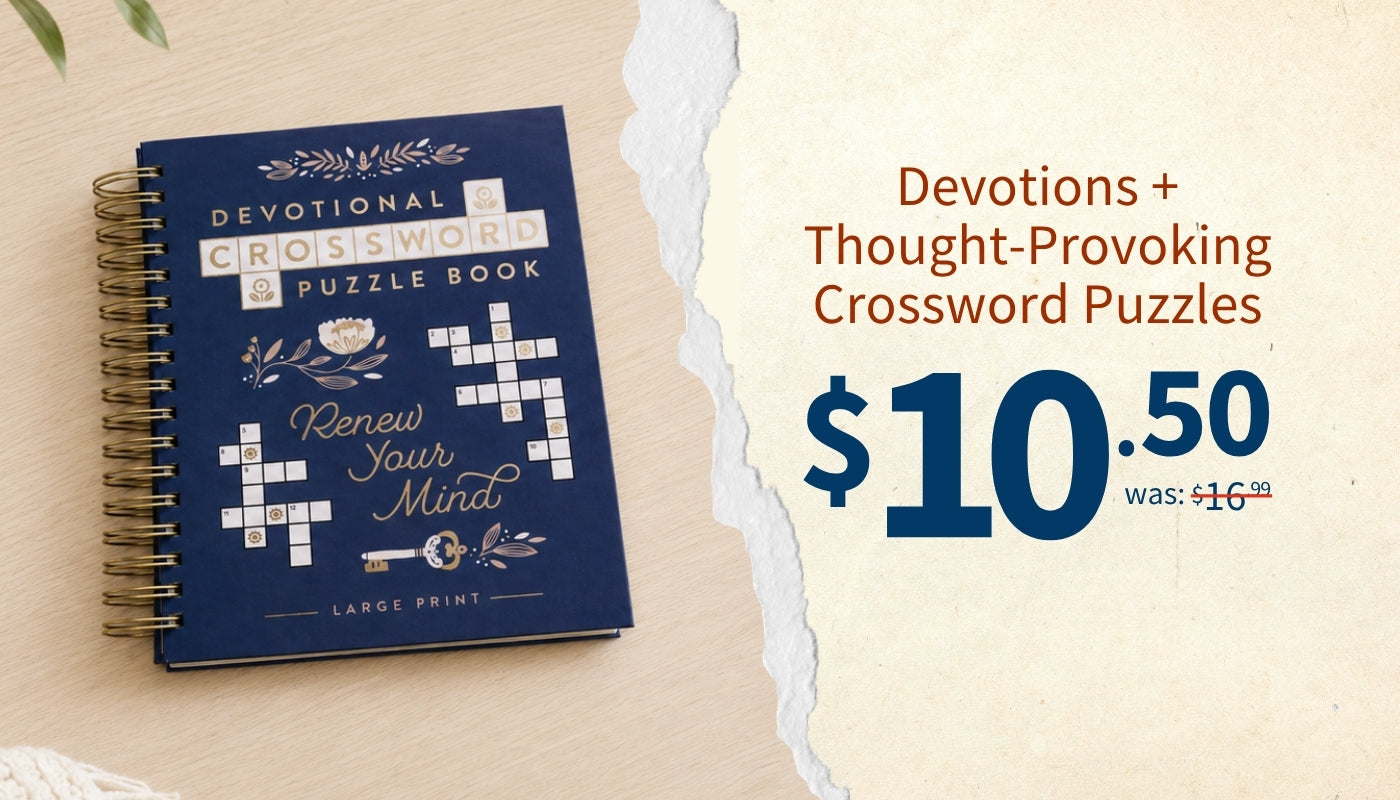 A dark blue spiral-bound puzzle book titled 'Devotional Crossisword Puzzle Book' by Lance Print, shown on a light wood surface next to a torn-paper style graphic with text advertising 'Devotions + Thought-Provoking Crossword Puzzles' and a price of $10.50.