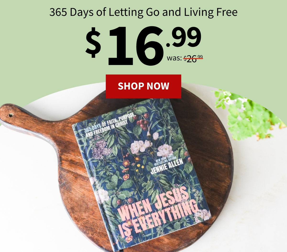 A book cover for 'When Jesus Is Everything' by Jennie Allen is displayed on a round wooden serving board over a white surface. Large promotional text above reads '365 Days of Letting Go and Living Free' with a price of $16.99 was $26.99.
