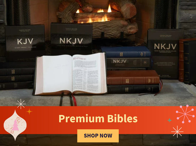 A set of premium Bible commentaries and an open NKJV Bible displayed on a stone shelf in front of a fireplace. The collection includes black boxes labeled KJV and NKJV, several blue and brown hardcover commentaries, and an open Bible showing the Matthew page.