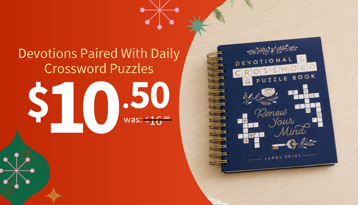 A promotional graphic showing a navy blue spiral-bound book titled 'Devotional Crossword Puzzle Book' on a light wood surface, with large orange text on the left reading '$10.50' and holiday-themed decorative graphics.
