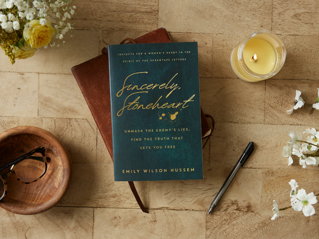 Sincerely, Stoneheart book on table with candle and pen